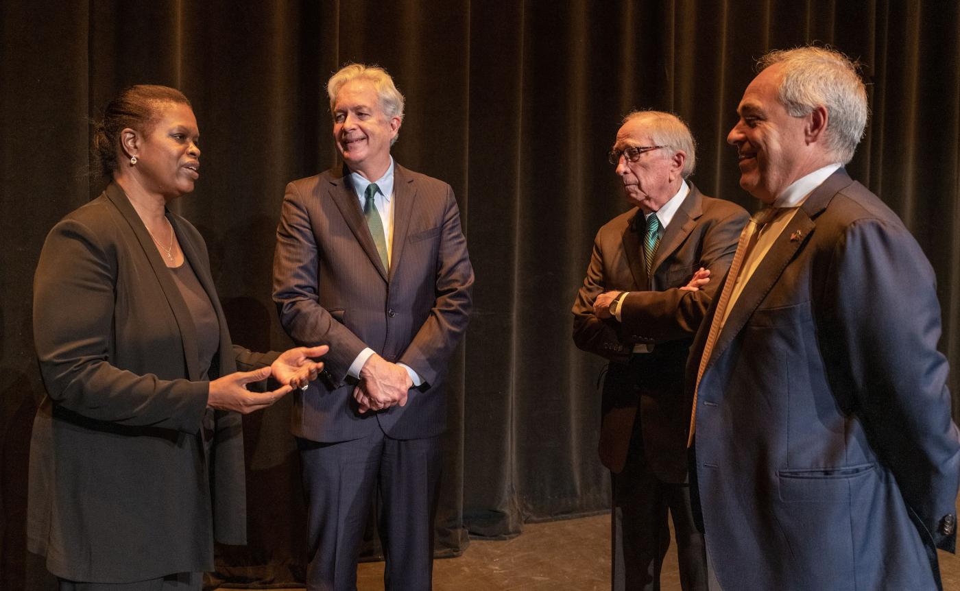 Kaye Husbands Fealing, William Burns, Sam Nunn, and Angel Cabrera stand together talking.