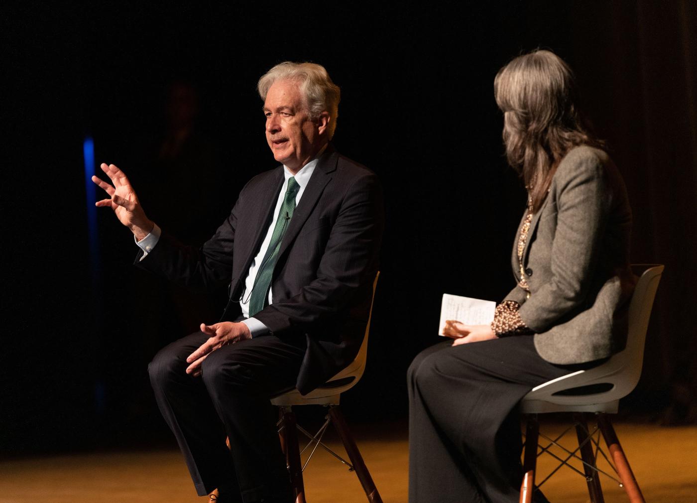 William Burns and Jenna Jordan sit in chairs on stage to answer audience questions.